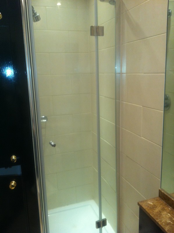 Frameless glass shower enclosure with chrome fittings in Kentish Town